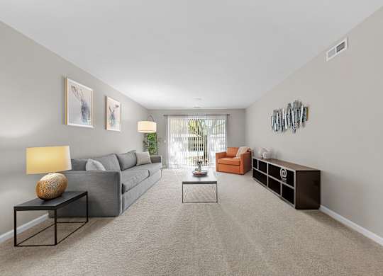 Spacious Living Room with Sliding Glass Door at Lakeside Village Apartments Clinton Township MI