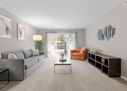 Spacious Living Room with Sliding Glass Door at Lakeside Village Apartments Clinton Township MI