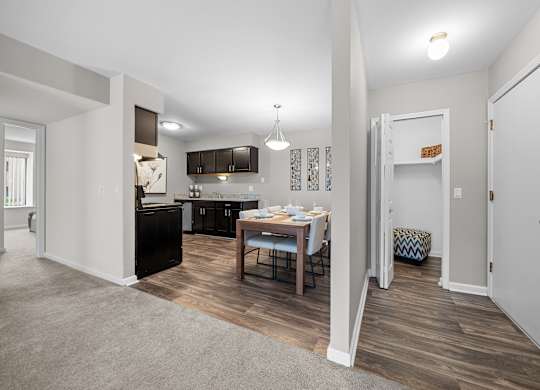 Open concept Living-Dining Area with natural lighting at Lakeside Village Apartments Clinton Township, MI