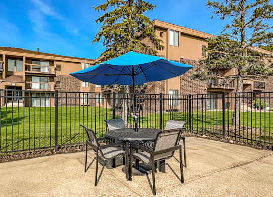 Umbrella and Chairs on Sundeck at Lakeside Village Apartments in Clinton Township