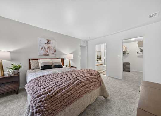 Cozy bedroom with bathroom and ample storage at Park Lane Apartments in Southfield, MI.