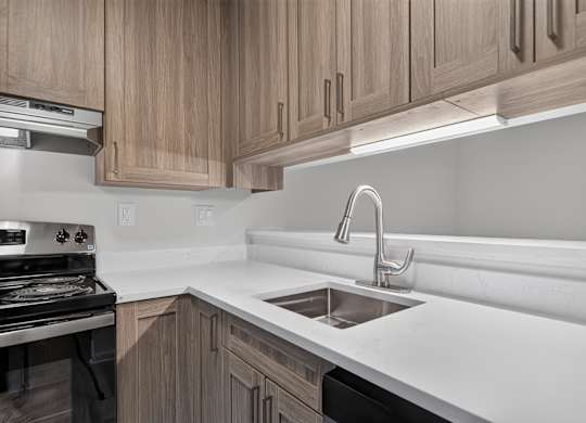 Modern kitchen with under cabinet lighting at Park Lane Apartments in Southfield, MI.