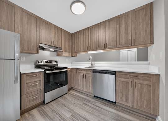 Stainless steel appliances and soft-close cabinets at Park Lane Apartments in Southfield, MI.