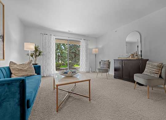 Spacious Living room with patio at Prentiss Pointe Apartments in Harrison Township