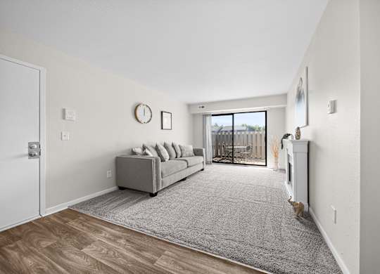 Large living room with patio at Three Oaks Apartments in Troy, Mi
