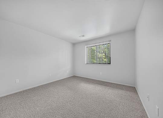 Spacious bedroom at Woodland Villa Apartments in Westland, MI.