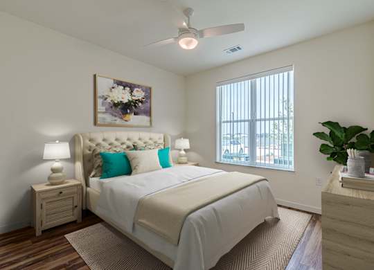 A bedroom with a large bed and a ceiling fan.