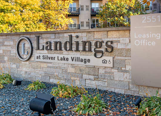 A sign for Landings at Silver Lake Village leasing office.