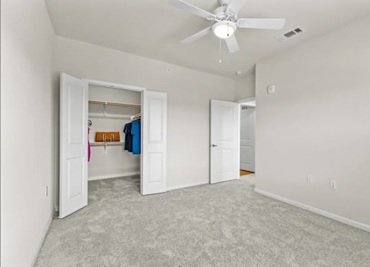 a bedroom with a closet and a ceiling fan at Cypress Creek at River Oaks, Waxahachie, 75165
