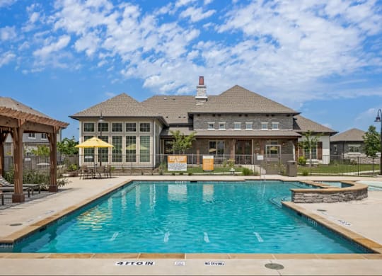 a large swimming pool in front of a house at Cypress Creek at River Oaks, Waxahachie, TX