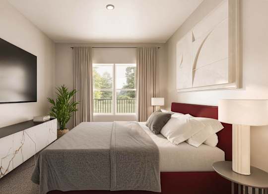 A bedroom with a large bed and a flat screen TV mounted on the wall at Sage at Franklin Park Apartment , Austin