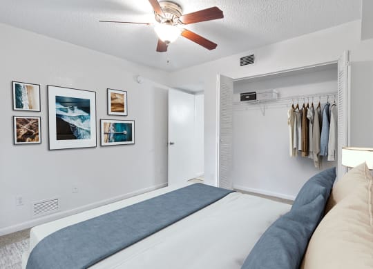 a bedroom with a bed and a ceiling fan