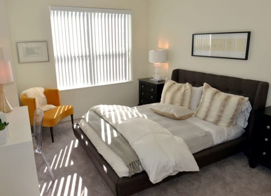 Cozy bed and window at 1500 Nicollet Apartment Homes, Minnesota