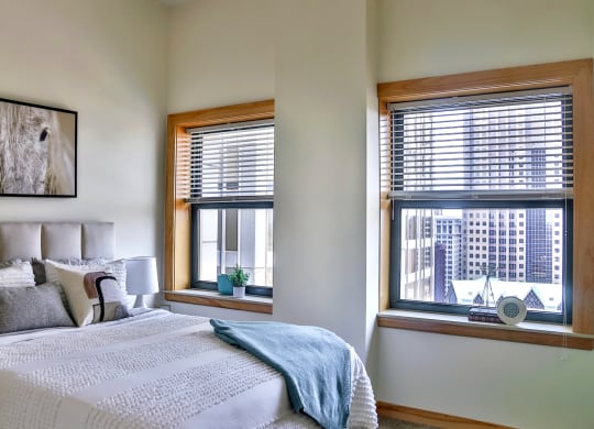 Bedroom with large windows at Arcade Apartments, St Louis, MO