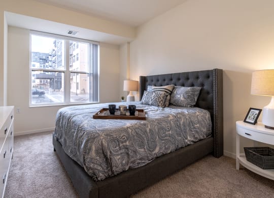 Dominium_Bren Road Station_-Bedroom with bed and lights at Bren Road Station 55+ Apartments, Minnetonka, 55343
