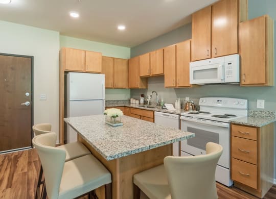 Kitchen with island at Covington Crossings 55+ Senior Living, Covington