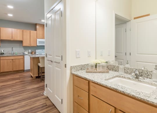 Bathroom with mirror at Covington Crossings 55+ Senior Living, Covington, 30014