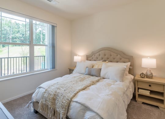 Bedroom with cozy bed at Covington Crossings 55+ Senior Living, Covington, GA, 30014