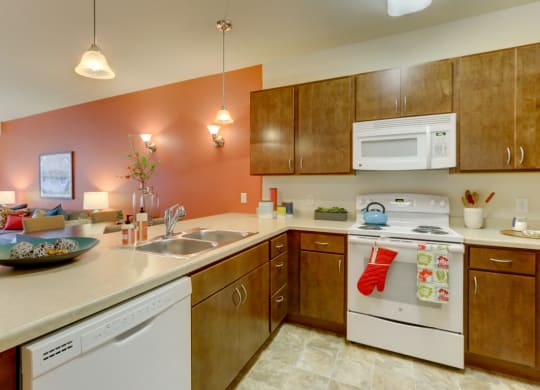Kitchen with gas stove at The Legends at Silver Lake Village 55+ Apartments, St. Anthony, Minnesota, 55421