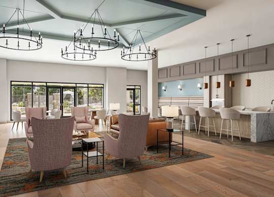 A modern dining room with a fireplace and a large table at Orchard Springs 55+ Apartment , Surprise, AZ