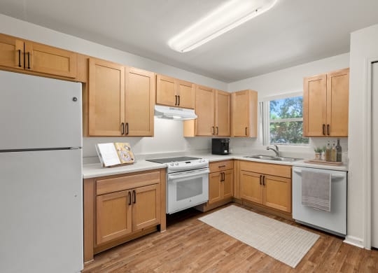 a kitchen with wooden cabinets and white appliances