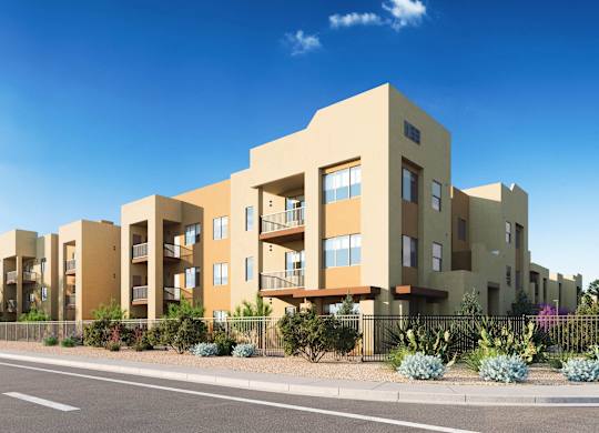 A modern apartment building with a clear blue sky above at Sandoval Flats Apartment , Rio Rancho, Minnesota
