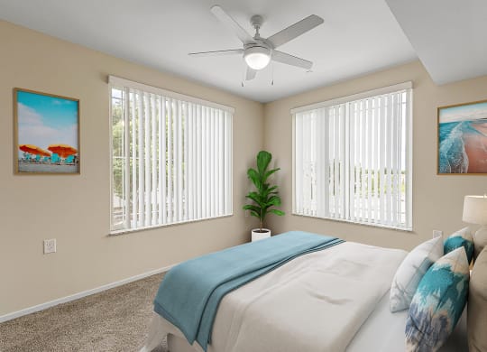 Bedroom with cozy bed and ceiling fan at Sandpiper Glen 62+ Apartments, Florida
