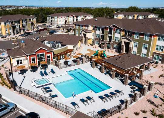 an aerial view of an apartment complex with a swimming pool