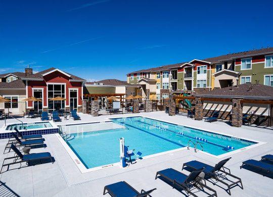 our apartments have a large swimming pool with chairs and tables