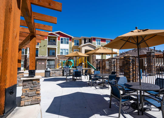 an outdoor patio with tables and chairs and umbrellas