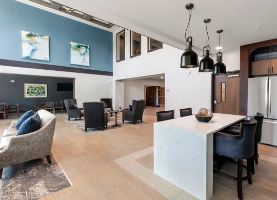 Clubroom seating area and kitchen at Stonepointe 55+ Apartments, Lithonia 30058