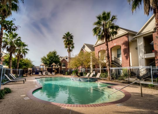 Pool with palm trees at Villa Springs, Houston, TX, 77090