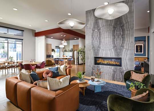 A modern living room with a fireplace and a variety of seating options.