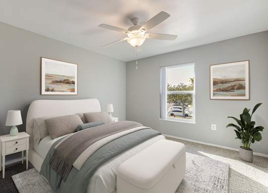 A bedroom with a large bed and a ceiling fan.