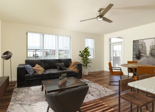 a living room with a couch and a table and a ceiling fan at Casa Azure 55+ Apartments, Phoenix, 85035
