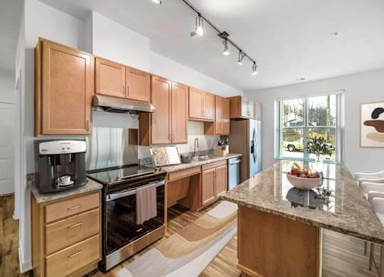 A kitchen with wooden cabinets and a marble countertop.at Creekridge on the Park, Charlotte, NC 28212