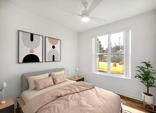 A bedroom with a bed, a ceiling fan, and two abstract paintings on the wall.at Creekridge on the Park, Charlotte North Carolina