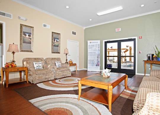 A living room with a couch, chair, and coffee table.