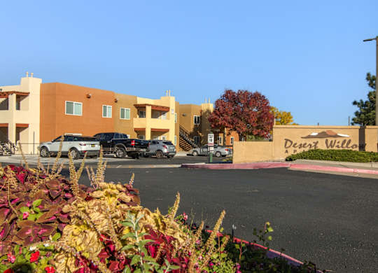 A parking lot in front of a building named