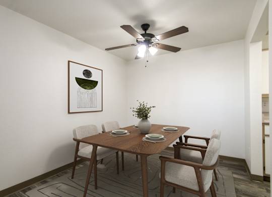 A dining room with a table set for four.