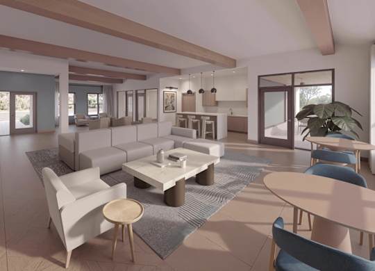 A modern living room with a white sofa set and a grey rug.