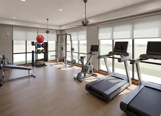 A gym with treadmills, elliptical machines, and other exercise equipment.