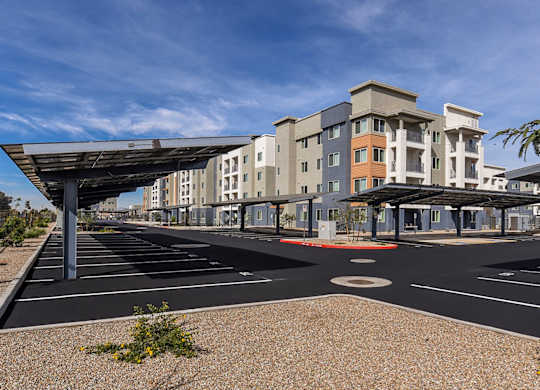 A parking lot with a large building in the background.
