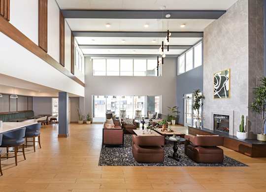 A large, modern living room with a fireplace and a dining area.