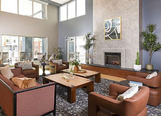 A living room with a fireplace and a painting on the wall.