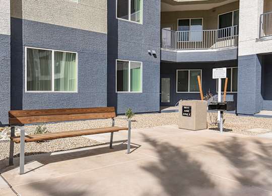 A bench sits in front of a building with a sign that says "The Park".