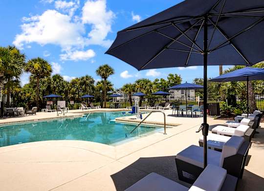 Pool With Relaxing Chairs at The Lucille Apartments, Stuart, 34996