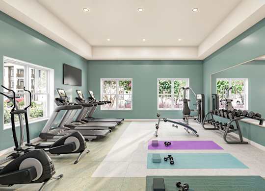 A well-lit gym with treadmills, exercise bikes, and dumbbells at Maison at Solivita Marketplace Apartment Homes, Kissimmee, FL, 34758
