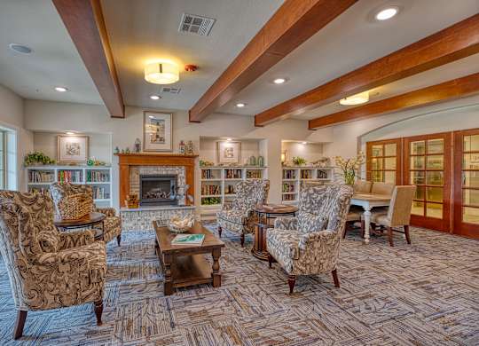a living room with couches and chairs and a fireplace at Mariposa at South Broadway, Joshua, 76058
