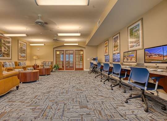 a large conference room with chairs and tables and a television at Mariposa at South Broadway, Texas, 76058